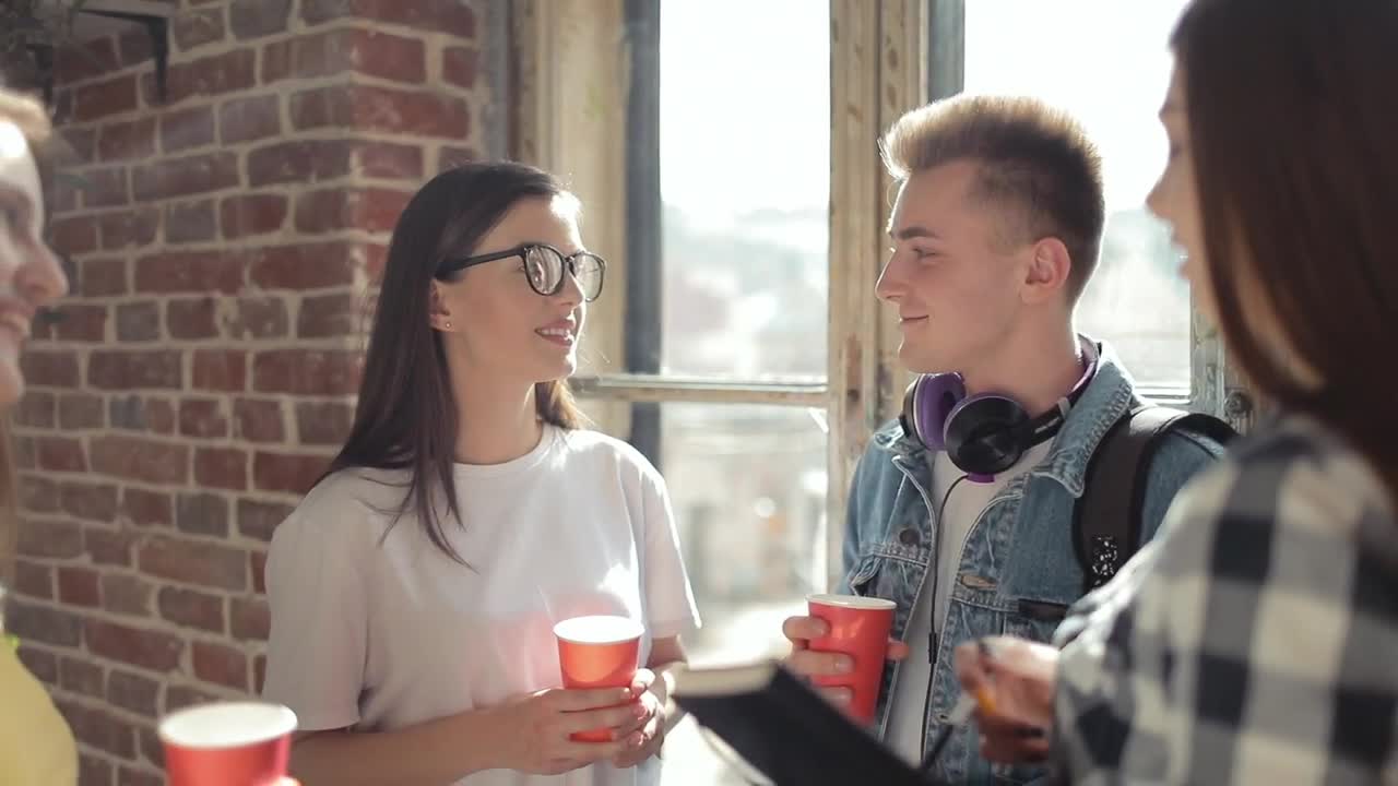 Free Video Stock Students Enjoy A Break In Front Of Sunlit Window Live Wallpaper - Free Download