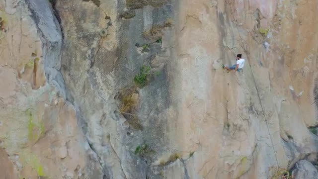 Stock Video Mountaineer Descending From A Large Mountain With A Rope Live Wallpaper - Free Download