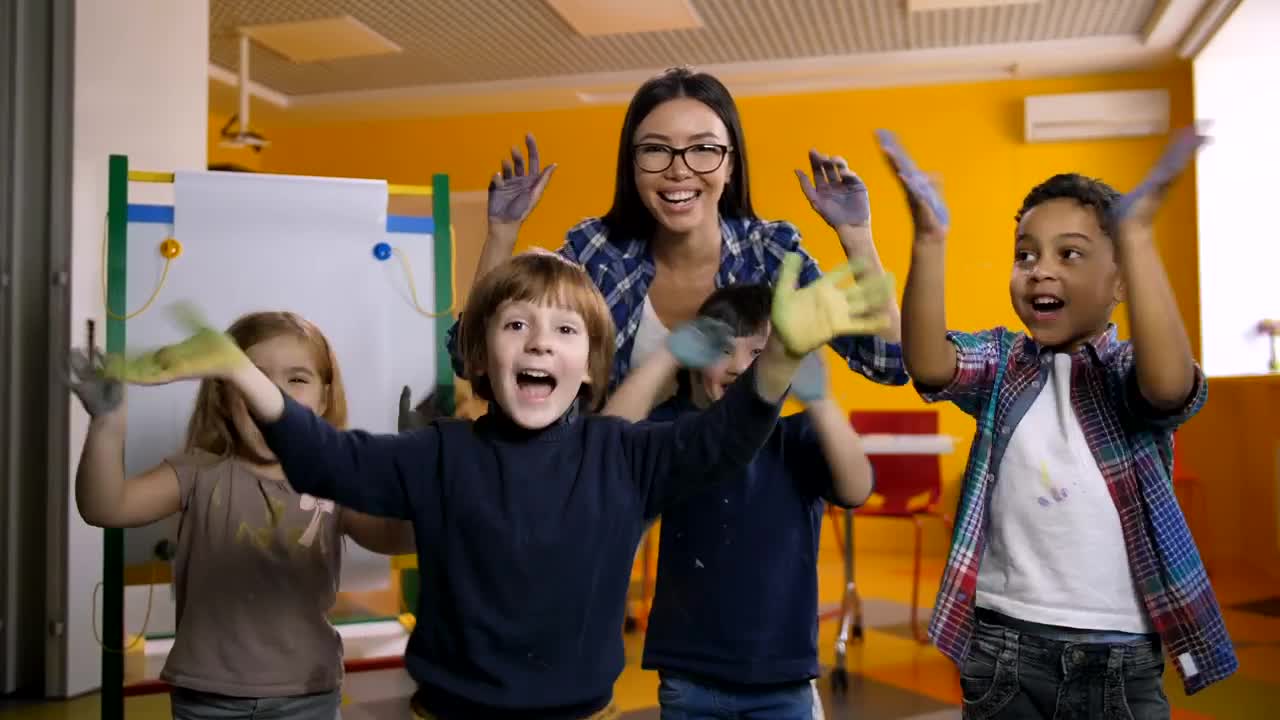 Free Video Stock teacher and students waving with painted hands Live Wallpaper - Free Download
