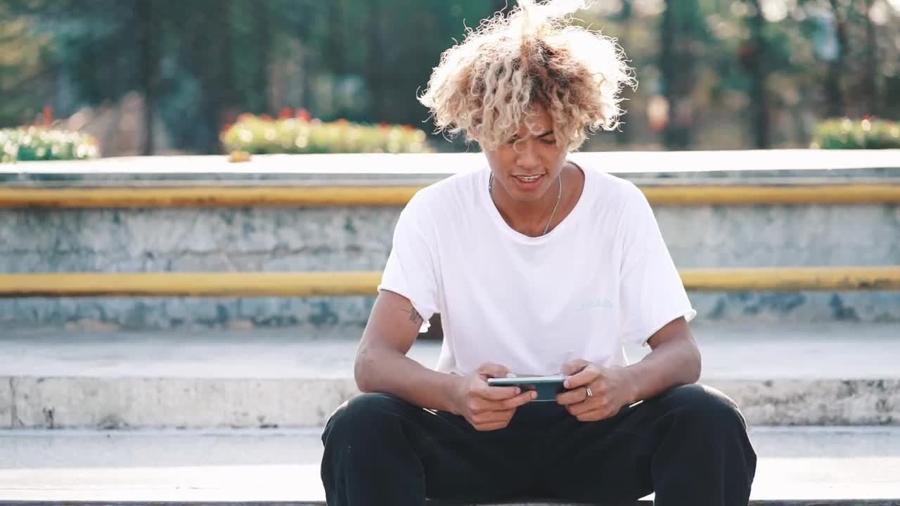 Free Video Stock Skater Texting And Looking At The Camera Live Wallpaper - Free Download