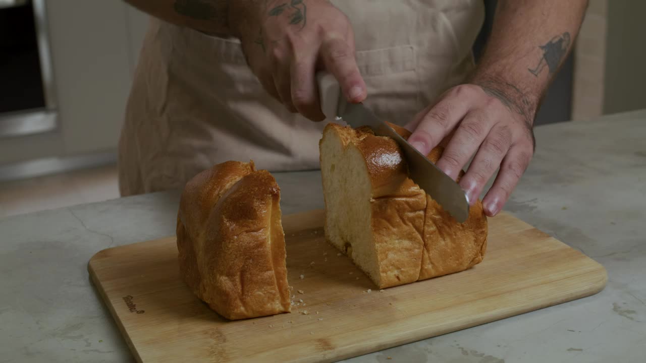 Stock Video Pastry Chef Cutting A Loaf Into Slices Live Wallpaper - Free Download
