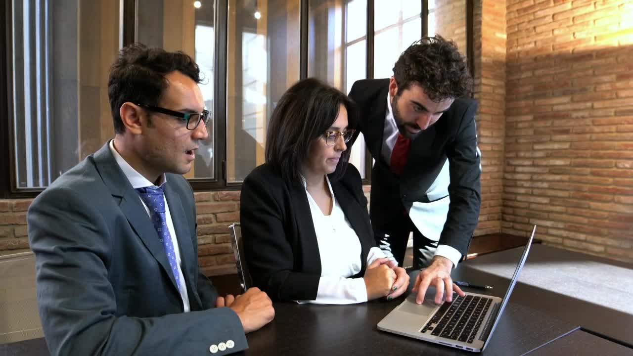 Free Video Stock three office colleagues working together Live Wallpaper - Free Download
